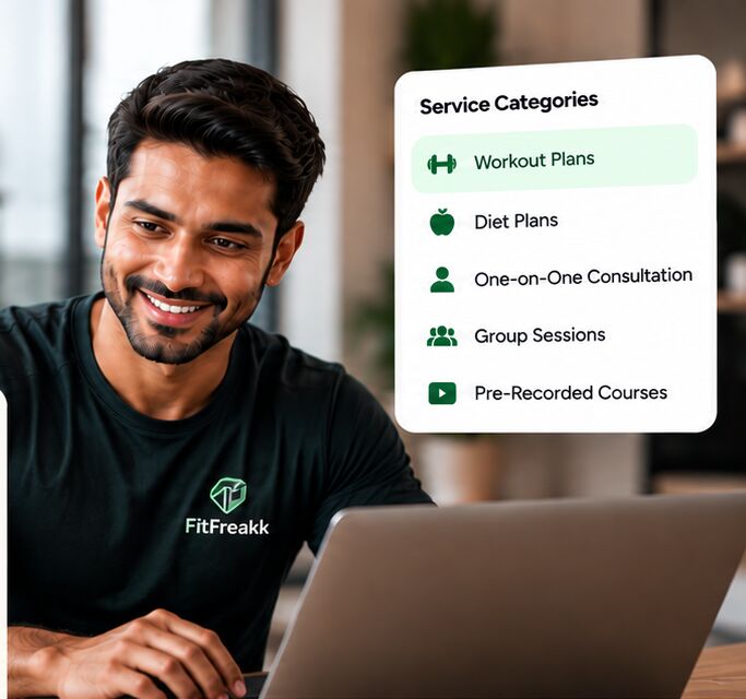 Smiling trainer at his laptop next to a list of service categories